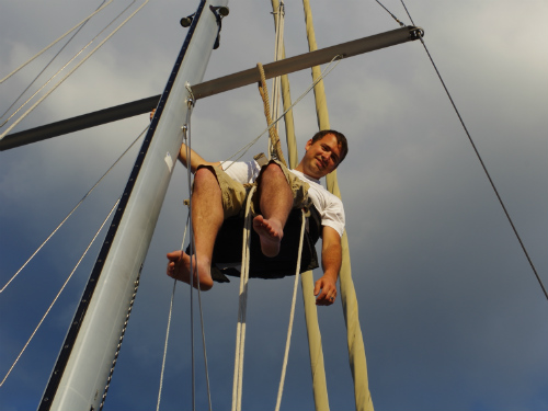 Dan going up the mast for the first time after borrowing a neighbor's block and tackle.